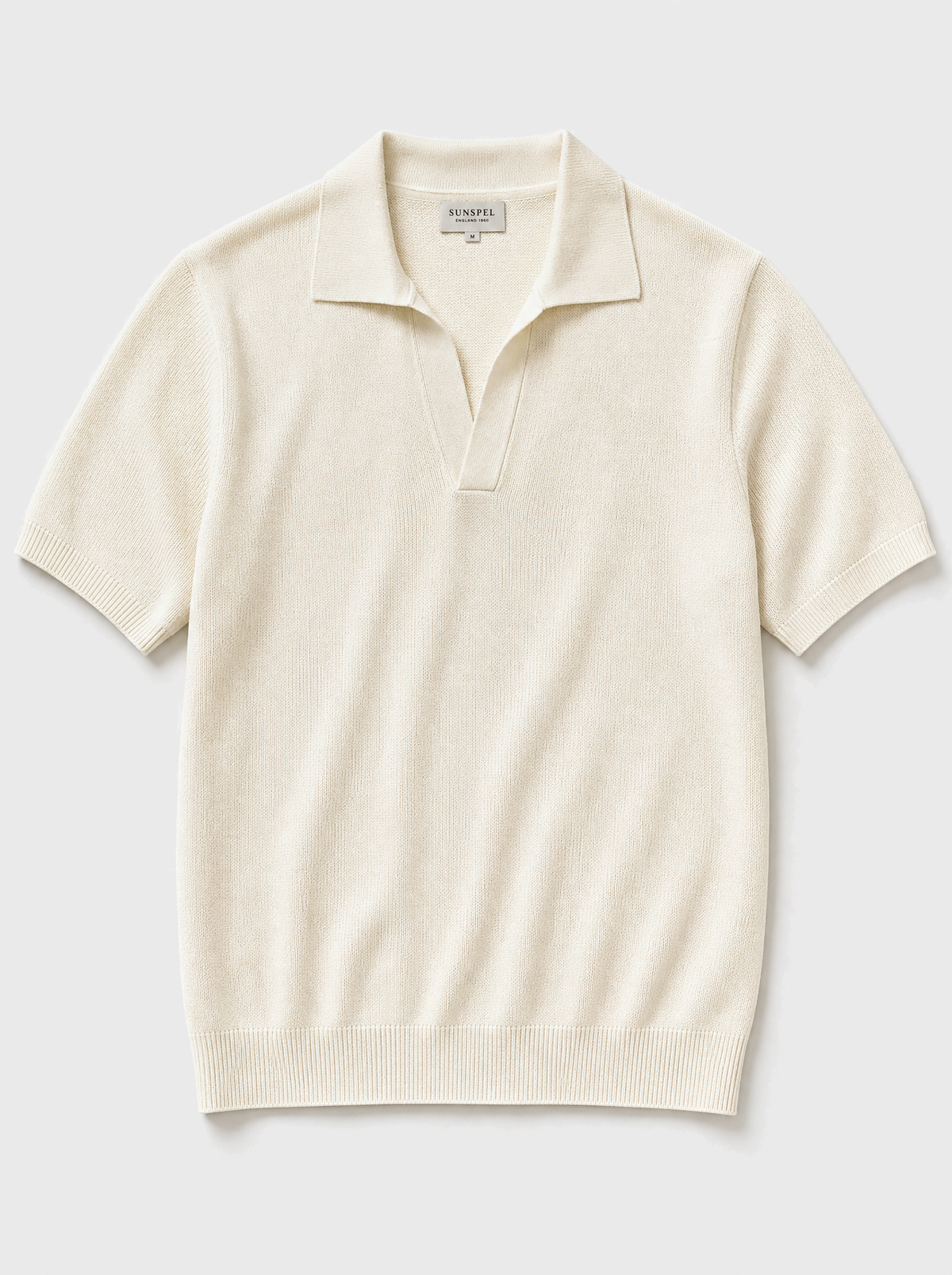 The Portofino Polo — ivory fine-gauge knit cotton short-sleeve henley polo, front view