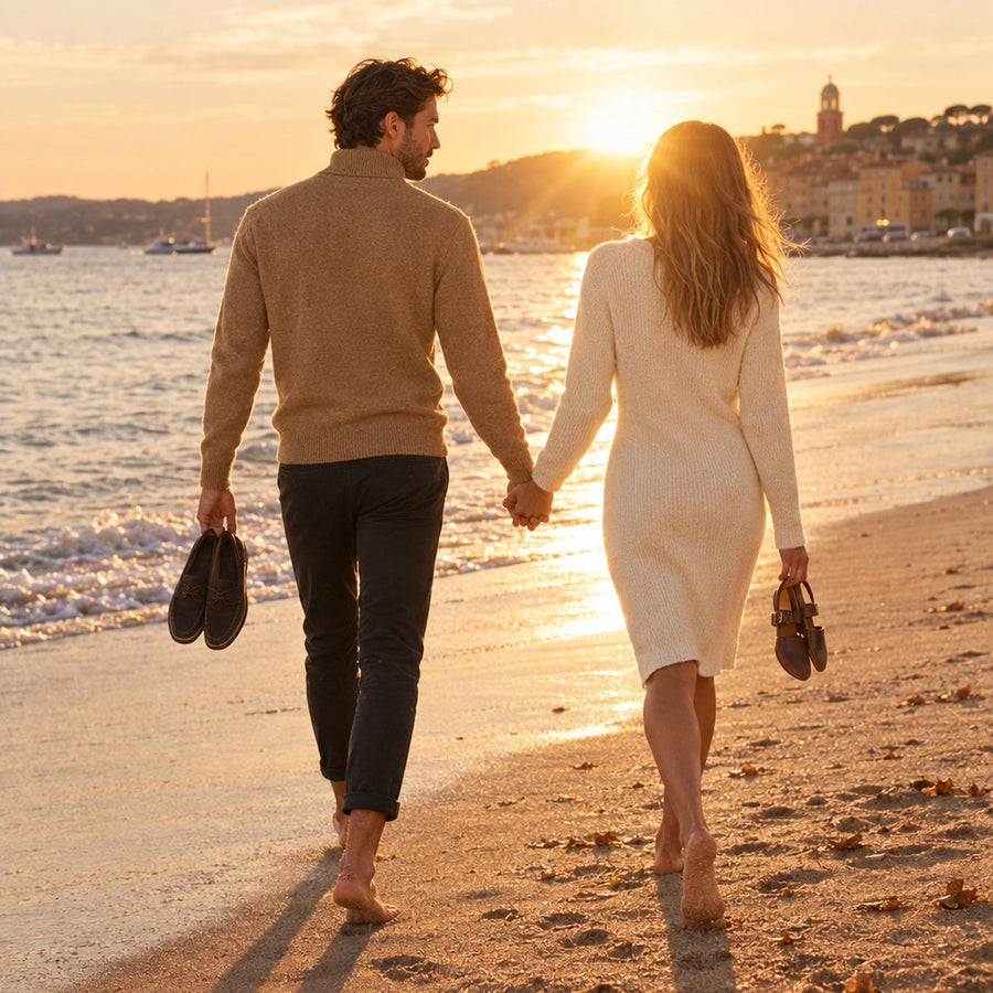 Couple walking a Saint-Tropez beach at sunset, he in the Camogli roll-neck