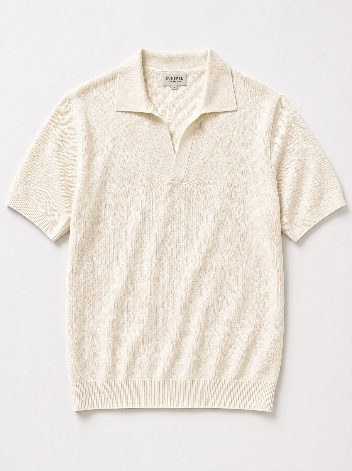 The Portofino Polo — ivory fine-gauge knit cotton short-sleeve henley polo, front view