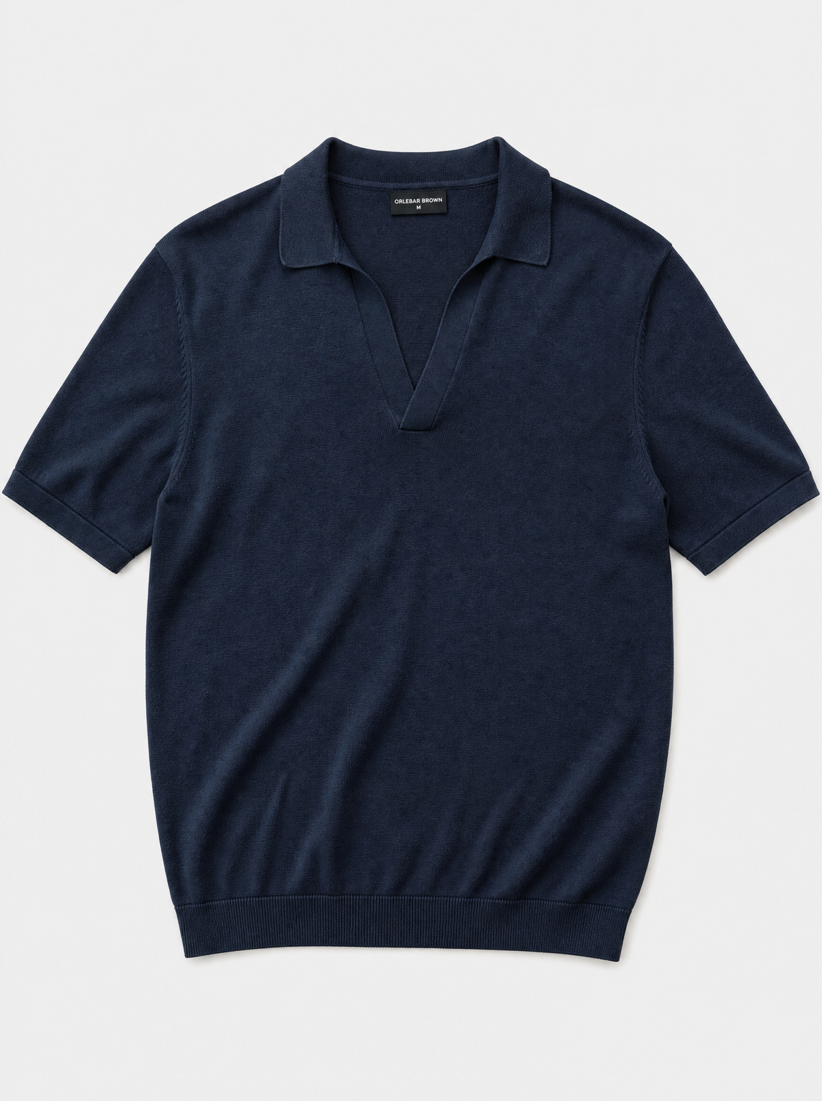 The Portofino Polo — navy fine-gauge knit cotton short-sleeve henley polo, front view