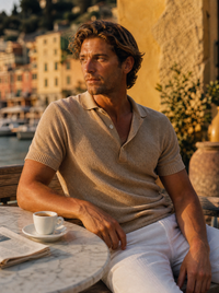 The Portofino Polo worn by model seated at a Portofino terrace cafe