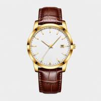 The Saint Veloir Timepiece — champagne gold case, white dial, cognac leather strap, flat-lay