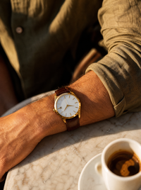 The Saint Veloir Timepiece worn by model with olive linen Lipari Shirt cuff at golden hour
