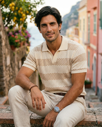 The Cadaques Polo - Sand Stripe on model, seated on Amalfi steps