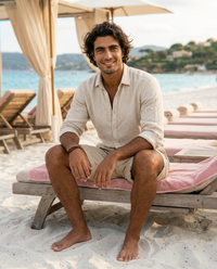 The Hydra Short - Sand on model, seated at beach club